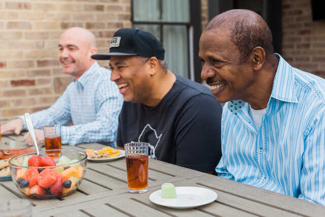 men laughing together during mens group outside